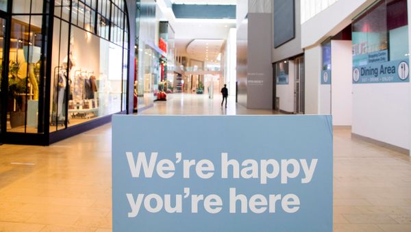 Person walks inside of Yorkdale Shopping Centre as the city enters the first day of a renewed coronavirus lockdown due to a spike in cases in Toronto, Ontario, Canada November 23, 2020 - Sputnik International