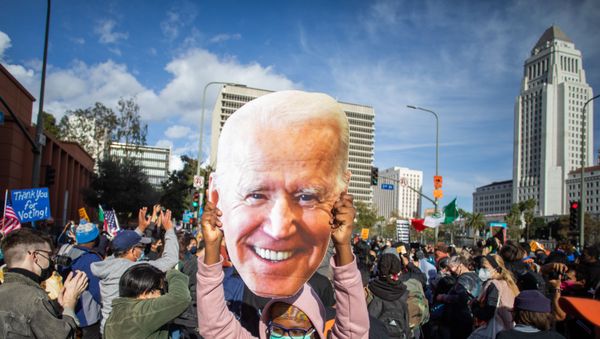 A woman holds a Joe Biden mask as people march in Los Angeles celebrating after Joe Biden was declared the winner of the 2020 presidential election on November 7, 2020. - Democrat Joe Biden has won the White House, US media said November 7, defeating Donald Trump and ending a presidency that convulsed American politics, shocked the world and left the United States more divided than at any time in decades. A woman holds a Joe Biden mask as people march in Los Angeles celebrating after Joe Biden was declared the winner of the 2020 presidential election on November 7, 2020. - Democrat Joe Biden has won the White House, US media said November 7, defeating Donald Trump and ending a presidency that convulsed American politics, shocked the world and left the United States more divided than at any time in decades. - Sputnik International