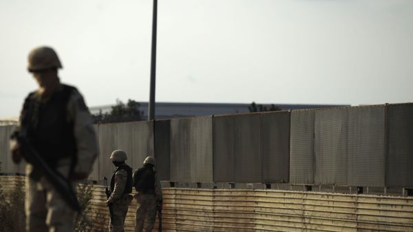 Soldiers guard next to a transportation warehouse where a tunnel was found, near the US-Mexico border in Tijuana, Mexico, Wednesday, Dec. 2, 2009 - Sputnik International