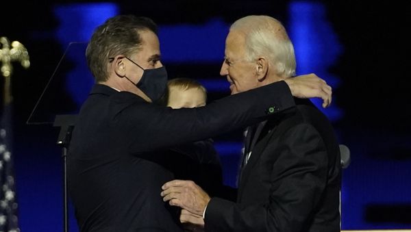 US President-elect Joe Biden (R) embraces his son Hunter Biden (L) on stage after delivering remarks in Wilmington, Delaware, on 7 November 2020. US President-elect Joe Biden (R) embraces his son Hunter Biden (L) on stage after delivering remarks in Wilmington, Delaware, on 7 November 2020. - Sputnik International