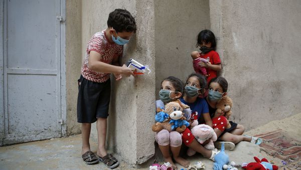 Palestinian children, mask-clad due to the Covid-19 coronavirus pandemic, play outside their house in Gaza City on 8 September Palestinian children, mask-clad due to the Covid-19 coronavirus pandemic, play outside their house in Gaza City on 8 September - Sputnik International