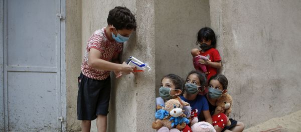 Palestinian children, mask-clad due to the Covid-19 coronavirus pandemic, play outside their house in Gaza City on 8 September Palestinian children, mask-clad due to the Covid-19 coronavirus pandemic, play outside their house in Gaza City on 8 September - Sputnik International