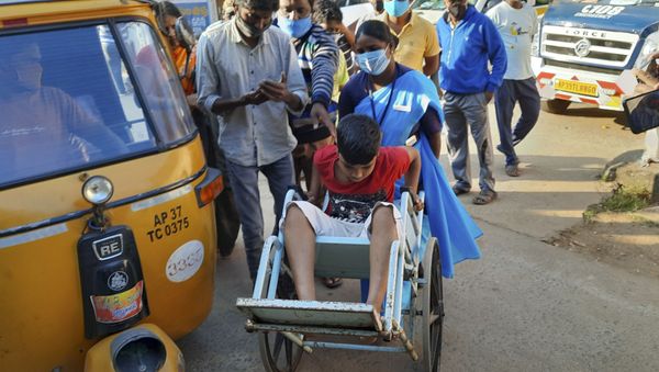 A young patient is brought in a wheelchair to the district government hospital in Eluru, Andhra Pradesh state, India, Sunday, Dec.6, 2020. A young patient is brought in a wheelchair to the district government hospital in Eluru, Andhra Pradesh state, India, Sunday, Dec.6, 2020. - Sputnik International