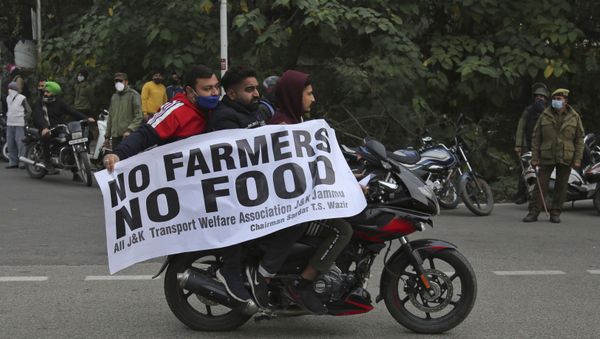 Protestors hold a placard and join others as they block the Jammu-Pathankot higway during a nationwide shutdown called by thousands of Indian farmers protesting new agriculture laws in Jammu India, Tuesday, Dec. 8, 2020 Protestors hold a placard and join others as they block the Jammu-Pathankot higway during a nationwide shutdown called by thousands of Indian farmers protesting new agriculture laws in Jammu India, Tuesday, Dec. 8, 2020 - Sputnik International
