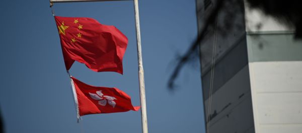 The Chinese (top) and Hong Kong flags flutter in Hong Kong on December 5, 2020.  - Sputnik International