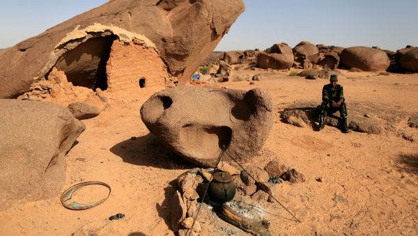 FILE PHOTO: A Polisario fighter sits on a rock at a forward base on the outskirts of Tifariti, Western Sahara, September 9, 2016 - Sputnik International