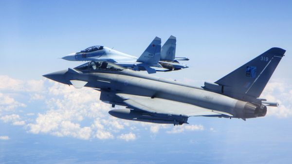 In this photo taken on Saturday, 15 June 2019, a Royal Air Force Typhoon jet, foreground, flies by a Su-30 Flanker fighter. - Sputnik International
