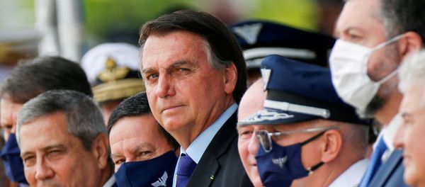 Brazil's President Jair Bolsonaro (C) looks on during a ceremony of Aviator's Day at Brasilia Air Base in Brasilia, Brazil 23 October, 2020.  - Sputnik International