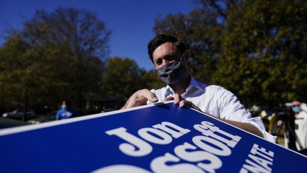 Georgia Democratic candidate for U.S. Senate Jon Ossoff grabs signs to give out during a drive-through yard sign pick-up event on Wednesday, Nov. 18, 2020, in Marietta, Ga. Ossoff and Republican candidate for Senate Sen. David Perdue are in a runoff election for the Senate seat. Georgia Democratic candidate for U.S. Senate Jon Ossoff grabs signs to give out during a drive-through yard sign pick-up event on Wednesday, Nov. 18, 2020, in Marietta, Ga. Ossoff and Republican candidate for Senate Sen. David Perdue are in a runoff election for the Senate seat. - Sputnik International