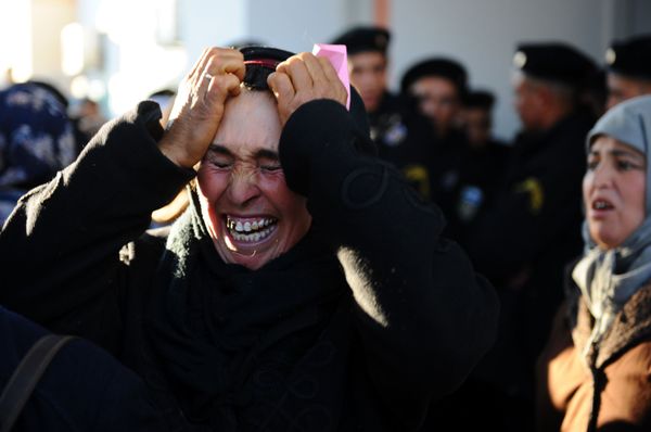 A woman cries in front of a prefecture as she waits with other people to meet the governor on 10 January 2011 in Sidi Bouzid A woman cries in front of a prefecture as she waits with other people to meet the governor on 10 January 2011 in Sidi Bouzid - Sputnik International