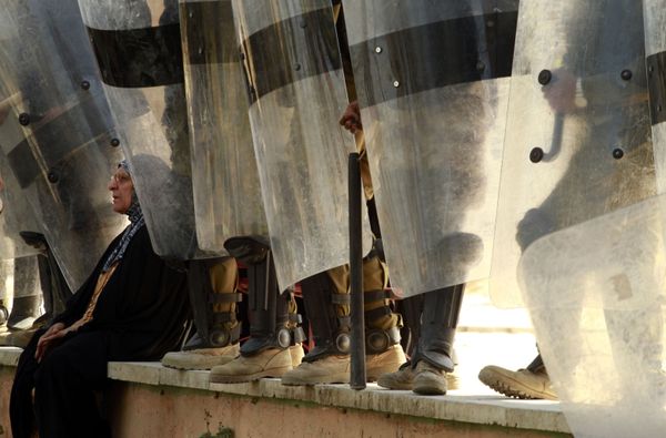 An Iraqi woman rests at the feet of riot police during a demonstration in Tahrir Square in central Baghdad, Iraq, Friday, 18 March 2011 An Iraqi woman rests at the feet of riot police during a demonstration in Tahrir Square in central Baghdad, Iraq, Friday, 18 March 2011 - Sputnik International