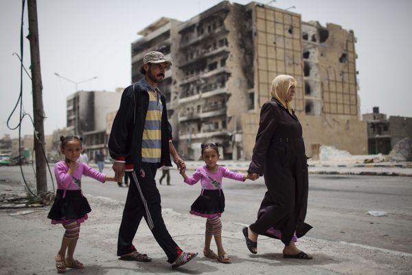 A family walks in Tripoli Street, the centre of the fighting between the rebels and Muammar Gaddafi’s forces in Misrata, Libya, Sunday, 22 May 2011 A family walks in Tripoli Street, the centre of the fighting between the rebels and Muammar Gaddafi’s forces in Misrata, Libya, Sunday, 22 May 2011 - Sputnik International