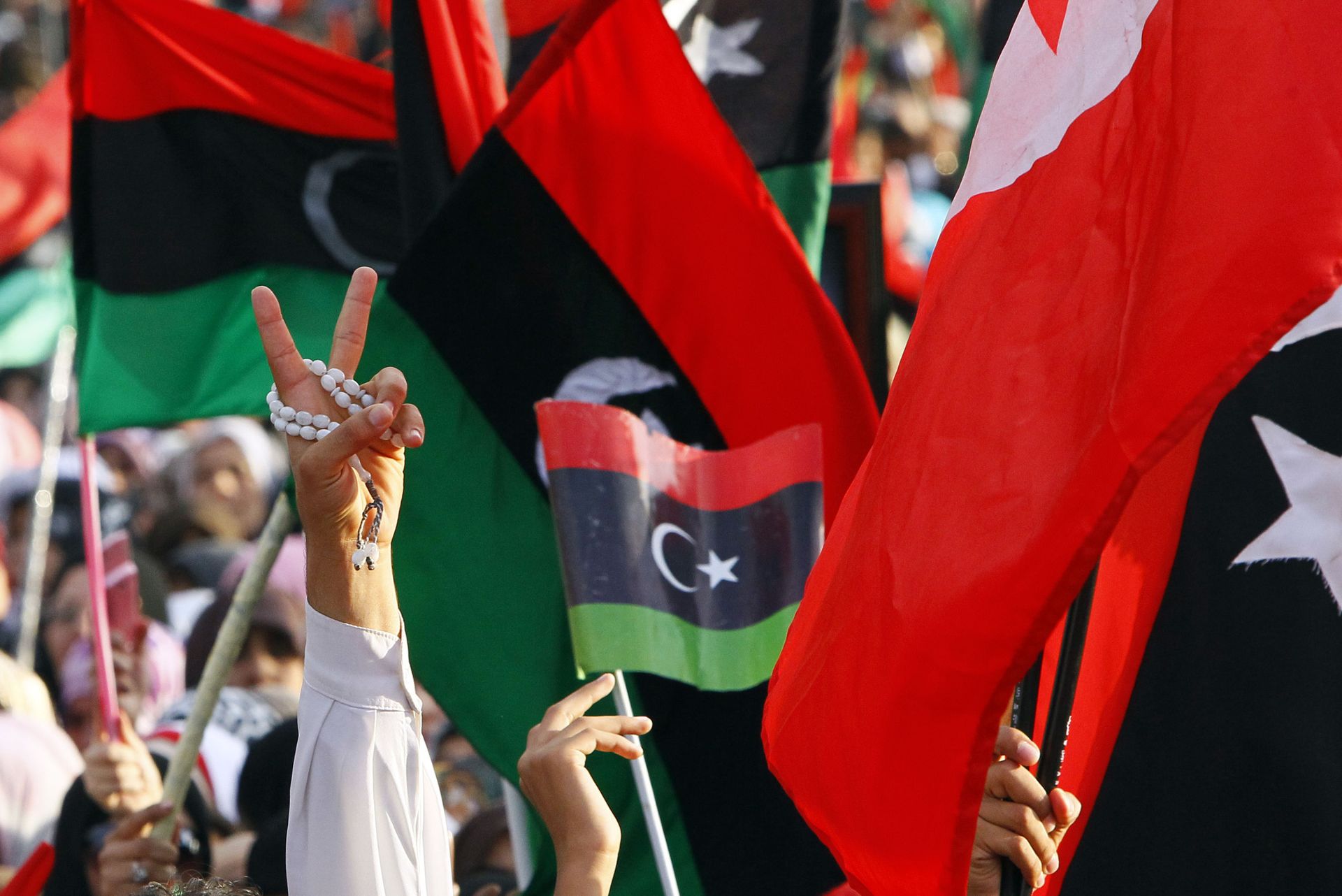 A Libyan flashes the V sign to celebrate at Saha Kish Square in Benghazi, Libya, Sunday Oct. 23, 2011 as Libya's transitional government declare liberation of Libya after months of bloodshed that culminated in the death of longtime leader Muammar Gaddafi. A Libyan flashes the V sign to celebrate at Saha Kish Square in Benghazi, Libya, Sunday Oct. 23, 2011 as Libya's transitional government declare liberation of Libya after months of bloodshed that culminated in the death of longtime leader Muammar Gaddafi. - Sputnik International, 1920, 21.12.2021
