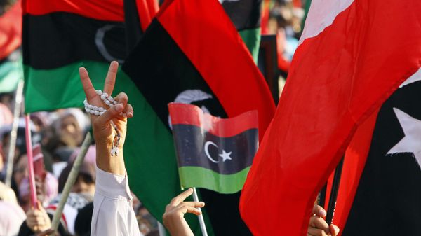 A Libyan flashes the V sign to celebrate at Saha Kish Square in Benghazi, Libya, 23 October 2011 as Libya's transitional government declares the liberation of Libya after months of bloodshed that culminated in the death of longtime leader Moammar Gaddafi.  - Sputnik International