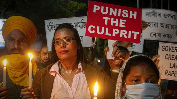 Indians hold placards protesting against the alleged gang rape and killing of a Dalit woman in Uttar Pradesh state, in Gauhati, India, Saturday, Oct. 10, 2020 - Sputnik International