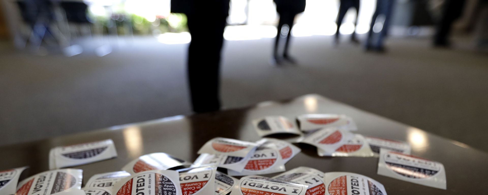 In this March 17, 2020, file photo I Voted stickers sit on the table for voters at Trinity Lutheran Church in Evanston, Ill. The U.S. intelligence community has warned over and over that foreign adversaries can and will interfere in the 2020 presidential election.  Just six weeks before the first ballots are cast, the threat has never been higher, and there are new signs that the nation’s electoral system is already under attack. - Sputnik International, 1920, 29.12.2023