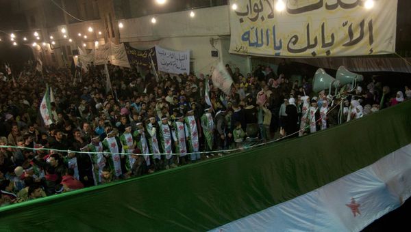 In this photo taken on Wednesday Dec. 21, 2011, anti-Syrian regime protesters, some wearing Syrian revolution flags, gather during a night demonstration in the Baba Amr area, in Homs province, Syria In this photo taken on Wednesday Dec. 21, 2011, anti-Syrian regime protesters, some wearing Syrian revolution flags, gather during a night demonstration in the Baba Amr area, in Homs province, Syria - Sputnik International