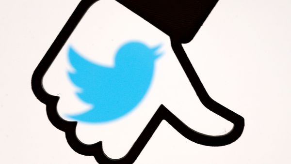 FILE PHOTO: A 3D-printed Facebook dislike button is seen in front of a displayed Twitter logo in this illustration taken October 25, 2017 - Sputnik International