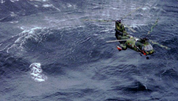 A helicopter circles an over turned lifeboat from the ferry Estonia, which sank in a storm off southwest Finland early on Wednesday September 28th./File Photo - Sputnik International
