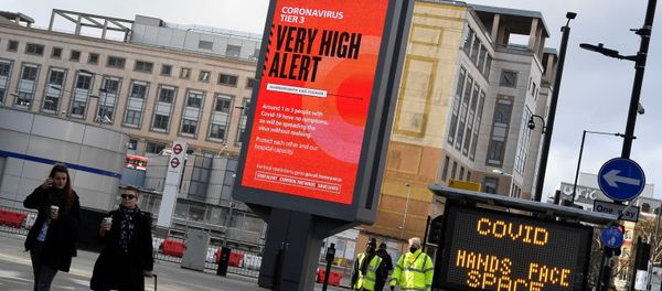 Pedestrians walk past a British government health information advertisement highlighting new restrictions amid the spread of the coronavirus disease (COVID-19), London, Britain Pedestrians walk past a British government health information advertisement highlighting new restrictions amid the spread of the coronavirus disease (COVID-19), London, Britain - Sputnik International