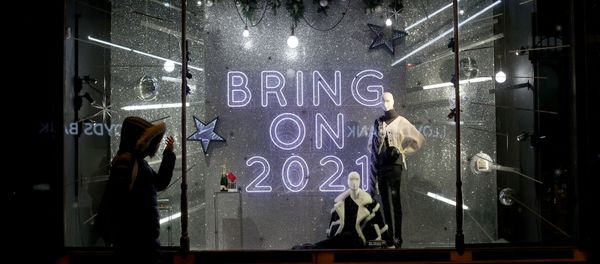 A person walks past a window display at Harvey Nichols in Leeds, Yorkshire, Britain December 19, 2020.  - Sputnik International