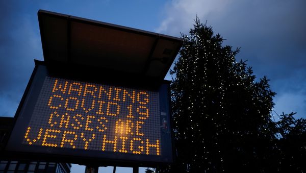 An electronic sign displays information as the British government imposes a stricter tiered set of restrictions amid the coronavirus disease (COVID-19) pandemic, in London, Britain, December 20, 2020. An electronic sign displays information as the British government imposes a stricter tiered set of restrictions amid the coronavirus disease (COVID-19) pandemic, in London, Britain, December 20, 2020. - Sputnik International