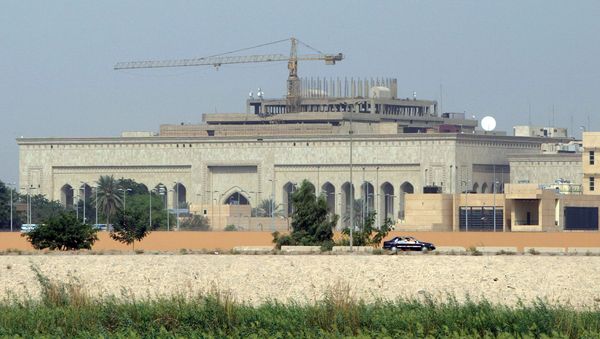 This file photo taken on October 11, 2007 shows in the forefront the US embassy complex in Baghdad and in the background, cranes towering over the construction site of the International High Tribunal (IHT) courthouse, in the heavily fortified Green Zone, on the west bank of the Tigris River in Baghdad - Sputnik International