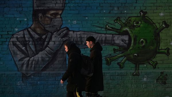 People walk past a graffiti depicting a healthcare worker fighting the virus, amid the outbreak of the coronavirus disease (COVID-19) in Omsk, Russia November 23, 2020 People walk past a graffiti depicting a healthcare worker fighting the virus, amid the outbreak of the coronavirus disease (COVID-19) in Omsk, Russia November 23, 2020 - Sputnik International