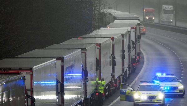 A police officer knocks on a cabin of one of lorries parked on the M20 motorway towards Eurotunnel and the Port of Dover, as EU countries impose a travel ban from the UK following the coronavirus disease (COVID-19) outbreak, in Folkestone, Britain, December 21, 2020.  - Sputnik International