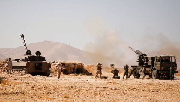 Hezbollah fighters stand near military tanks in Western Qalamoun, Syria August 23, 2017.  - Sputnik International
