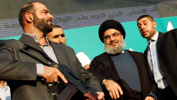 Lebanon's Hezbollah leader Sayyed Hassan Nasrallah (2nd R), escorted by his bodyguards, greets his supporters at an anti-U.S. protest in Beirut's southern suburbs, Lebanon September 17, 2012. - Sputnik International
