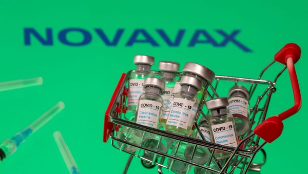 FILE PHOTO: A small shopping basket filled with vials labeled COVID-19 - Coronavirus Vaccine and medical sryinges are placed on a Novavax logo in this illustration taken November 29, 2020. Picture taken November 29, 2020. REUTERS/Dado Ruvic/Ilustration/File Photo FILE PHOTO: A small shopping basket filled with vials labeled COVID-19 - Coronavirus Vaccine and medical sryinges are placed on a Novavax logo in this illustration taken November 29, 2020. Picture taken November 29, 2020. REUTERS/Dado Ruvic/Ilustration/File Photo - Sputnik International