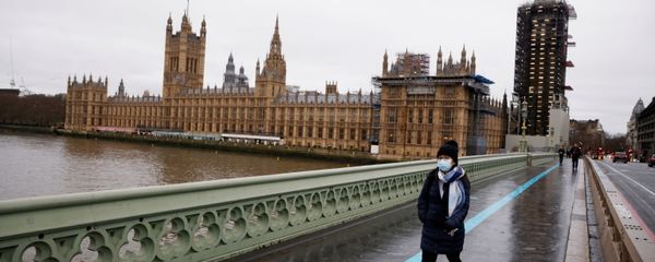 A woman wearing a face mask walks across Westminster Bridge past the Houses of Parliament, as the spread of the coronavirus disease (COVID-19) continues, in London, Britain, December 22, 2020 - Sputnik International