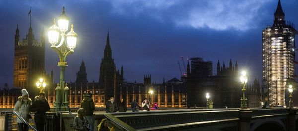 The Houses of Parliament can be seen as people walk across Westminster Bridge, during the New Year's Eve amid the coronavirus disease (COVID-19) outbreak, in London, Britain December 31, 2020 - Sputnik International