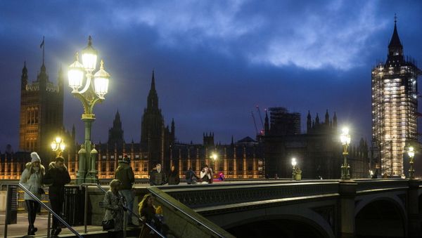 The Houses of Parliament can be seen as people walk across Westminster Bridge, during the New Year's Eve amid the coronavirus disease (COVID-19) outbreak, in London, Britain December 31, 2020 - Sputnik International