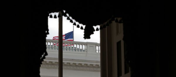 An American flag waves outside a window at the U.S. Capitol shortly before the Senate adjourns for the year, on Capitol Hill in Washington, U.S., December 31, 2020 An American flag waves outside a window at the U.S. Capitol shortly before the Senate adjourns for the year, on Capitol Hill in Washington, U.S., December 31, 2020 - Sputnik International