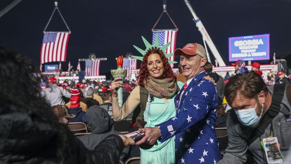 Supporters mingle before a rally with the US president in support of Republican incumbent senators Kelly Loeffler and David Perdue ahead of a Senate runoff in Dalton, Georgia on January 4, 2021. - Sputnik International