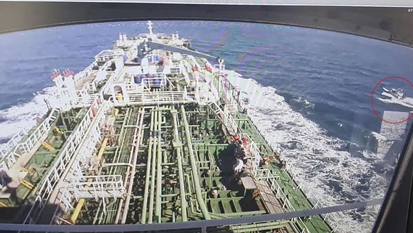 A CCTV footage of the Hankuk Chemi, a South Korean-flagged oil tanker, is displayed on a screen as a boat of Iran's Revolutionary Guards is seen in red circle on the screen at the tanker's owner company DM Shipping, in Busan on January 4, 2021. - South Korea's foreign ministry on January 4 demanded the early release of an oil tanker seized by Iran in Gulf waters for breaking maritime environmental laws. (Photo by - / YONHAP / AFP) / - South Korea OUT / REPUBLIC OF KOREA OUT  NO ARCHIVES  RESTRICTED TO SUBSCRIPTION USE - Sputnik International