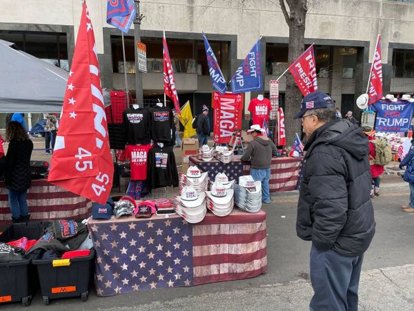 A man looks at caps and hats with pro-Trump slogans during a rally in DC. A man looks at caps and hats with pro-Trump slogans during a rally in DC. - Sputnik International