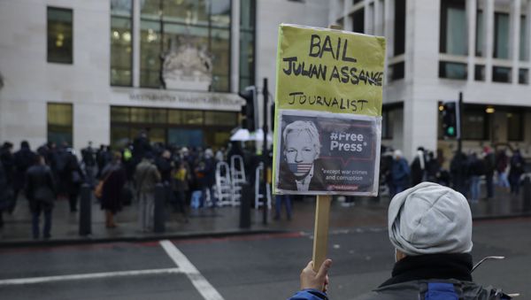 A Julian Assange supporter holds up a placard outside Westminster Magistrates Court as his bail hearing is held at the court in London, Wednesday, Jan. 6, 2021. On Monday Judge Vanessa Baraitser ruled that Julian Assange cannot be extradited to the US. because of concerns about his mental health. Assange had been charged under the US's 1917 Espionage Act for unlawfully obtaining and disclosing classified documents related to the national defence. Assange remains in custody, the US. has 14 days to appeal against the ruling.(AP Photo/Matt Dunham) - Sputnik International