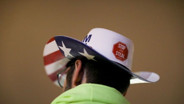 A supporter of U.S. President Donald Trump wearing a hat with a sticker on it reading Stop the Steal attends a rally ahead of the U.S. Congress certification of the November 2020 election results, during protests in Washington, U.S., January 5, 2021. A supporter of U.S. President Donald Trump wearing a hat with a sticker on it reading Stop the Steal attends a rally ahead of the U.S. Congress certification of the November 2020 election results, during protests in Washington, U.S., January 5, 2021. - Sputnik International