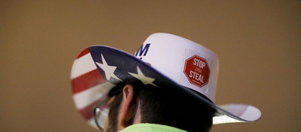 A supporter of U.S. President Donald Trump wearing a hat with a sticker on it reading Stop the Steal attends a rally ahead of the U.S. Congress certification of the November 2020 election results, during protests in Washington, U.S., January 5, 2021. A supporter of U.S. President Donald Trump wearing a hat with a sticker on it reading Stop the Steal attends a rally ahead of the U.S. Congress certification of the November 2020 election results, during protests in Washington, U.S., January 5, 2021. - Sputnik International