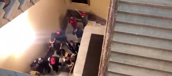 Screenshot captures a group of pro-Trump supporters storming the US Capitol Building amid Congress' certification of the Electoral College results. Screenshot captures a group of pro-Trump supporters storming the US Capitol Building amid Congress' certification of the Electoral College results. - Sputnik International