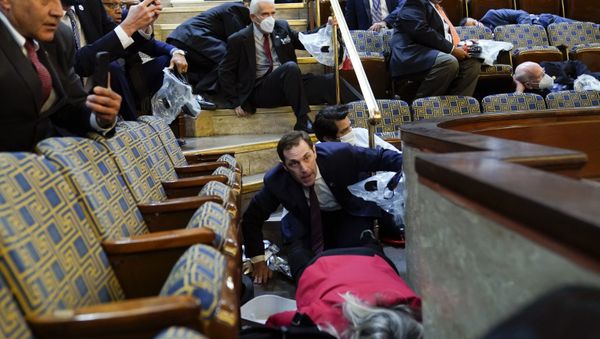 People shelter in the House gallery as protesters try to break into the House Chamber at the U.S. Capitol on Wednesday, Jan. 6, 2021, in Washington. - Sputnik International