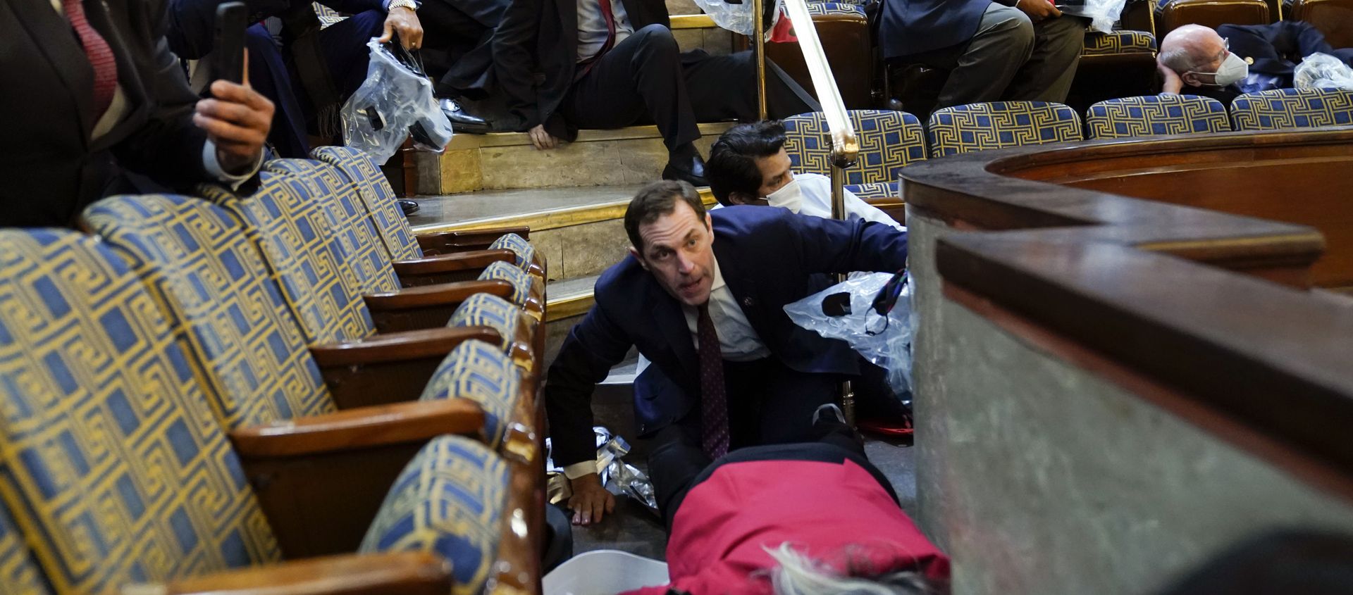 People shelter in the House gallery as protesters try to break into the House Chamber at the U.S. Capitol on Wednesday, Jan. 6, 2021, in Washington. People shelter in the House gallery as protesters try to break into the House Chamber at the U.S. Capitol on Wednesday, Jan. 6, 2021, in Washington. - Sputnik International, 1920, 06.01.2021