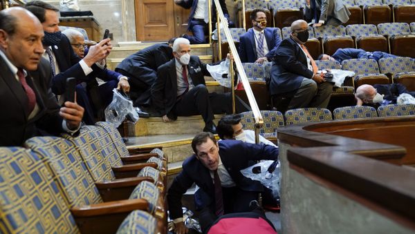 People shelter in the House gallery as protesters try to break into the House Chamber at the U.S. Capitol on Wednesday, Jan. 6, 2021, in Washington People shelter in the House gallery as protesters try to break into the House Chamber at the U.S. Capitol on Wednesday, Jan. 6, 2021, in Washington - Sputnik International
