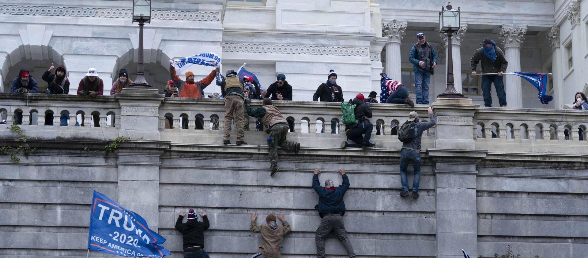 Supporters of President Donald Trump climb the west wall of the the US Capitol on Wednesday, Jan. 6, 2021, in Washington - Sputnik International, 1920, 16.02.2021