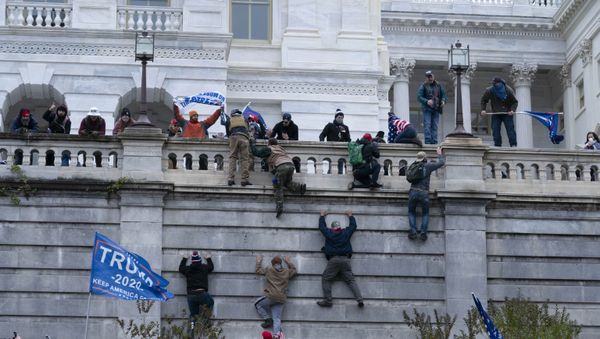 Supporters of President Donald Trump climb the west wall of the the US Capitol on Wednesday, Jan. 6, 2021, in Washington - Sputnik International