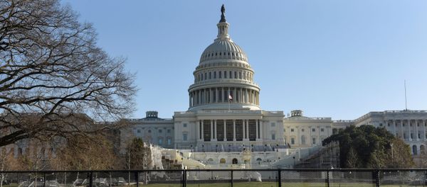 National Guard members walk behind a fence installed in front of the U.S. Capitol, a day after supporters of U.S. President Donald Trump occupied the Capitol building, in Washington, U.S. January 7, 2021. - Sputnik International