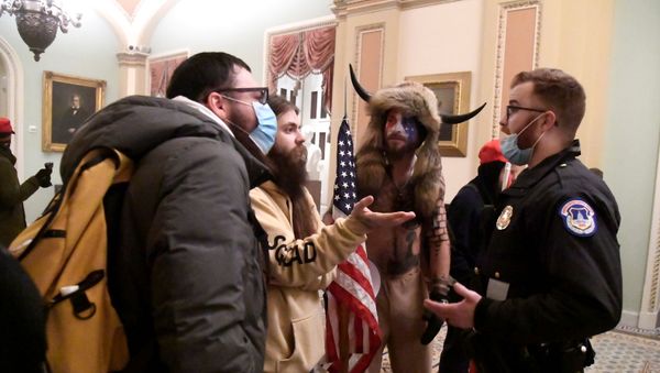 Police confront supporters of President Donald Trump as they demonstrate on the second floor of the U.S. Capitol near the entrance to the Senate after breaching security defenses, in Washington, U.S., January 6, 2021. - Sputnik International
